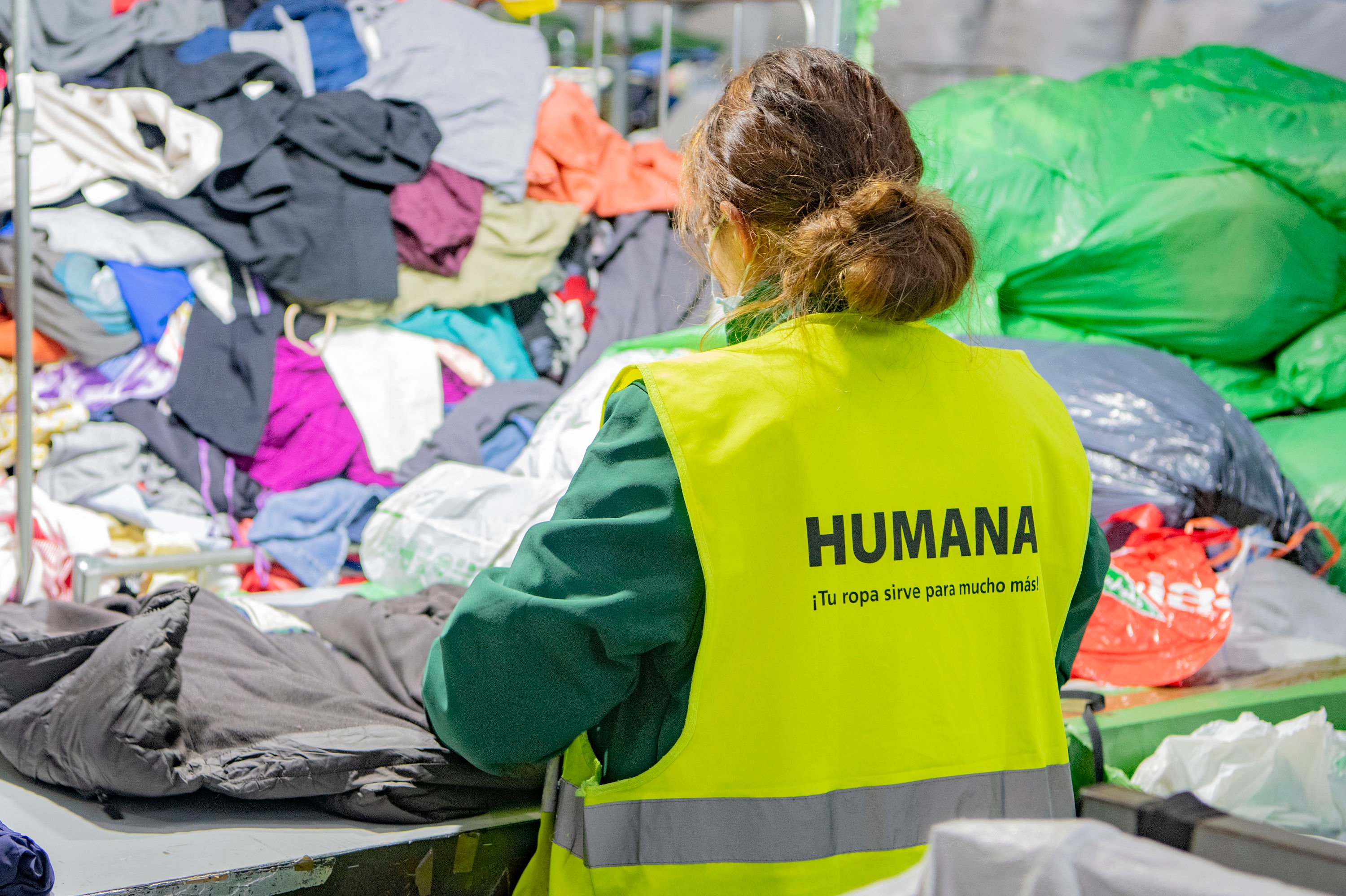Humana Sorting Center-woman sorting at a table