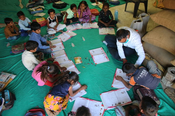 Teacher from India NeTT program working with children.