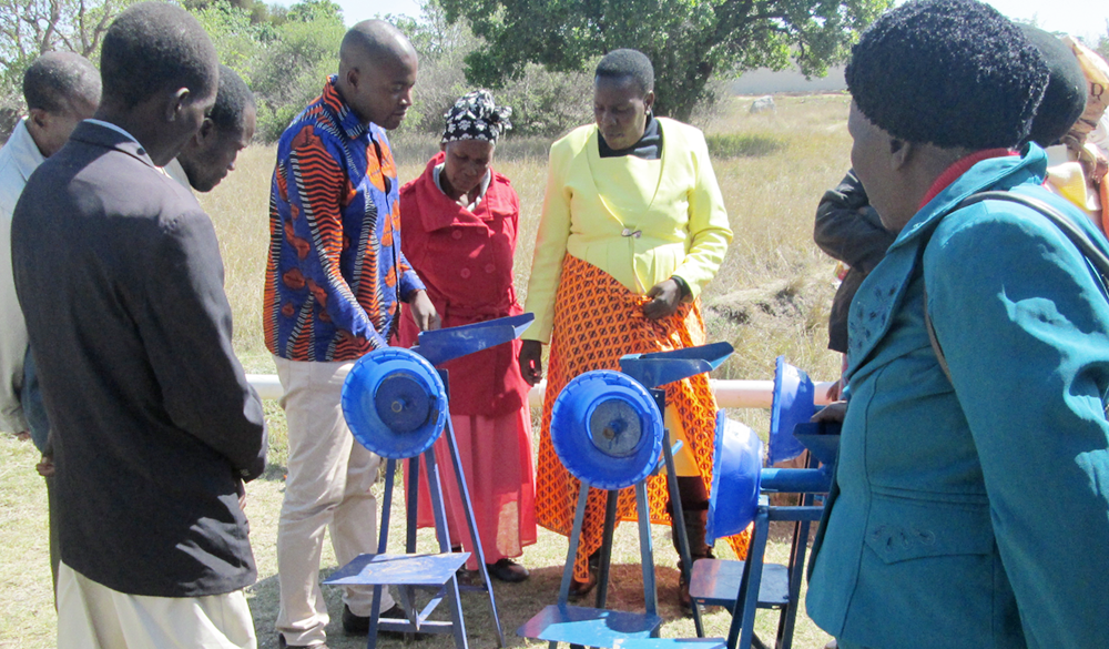 demonstrating the use of a manual peanut butter machine