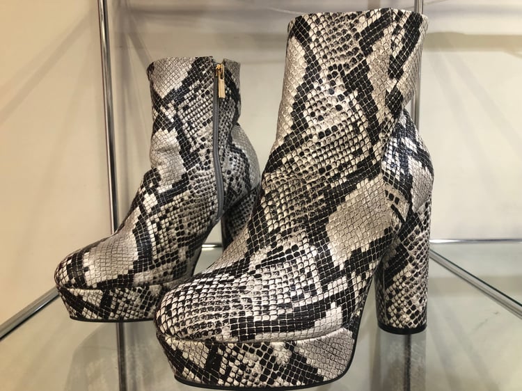 Snake-skin shoes at boutique at Planet Aid Thrift Store