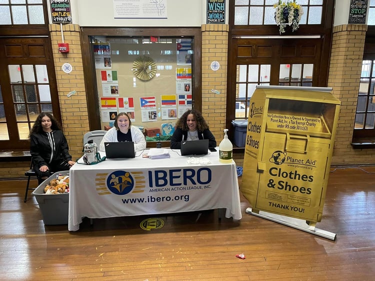Ibero-American Action League at table for Coat Giveaway
