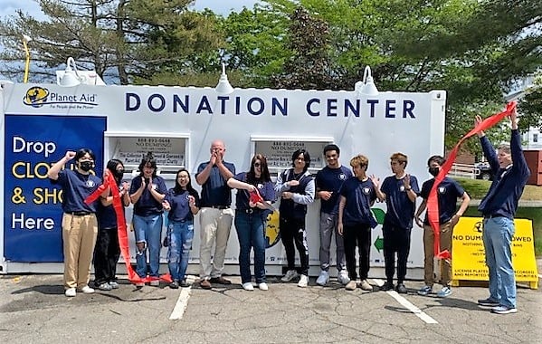 Cutting the ribbon on a new Planet Aid donation center