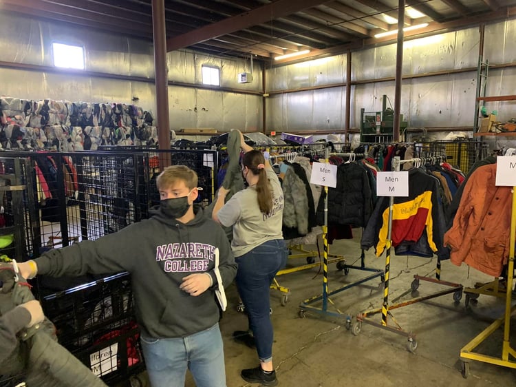 Volunteers organizing clothes for annual coat drive in Rochester, NY