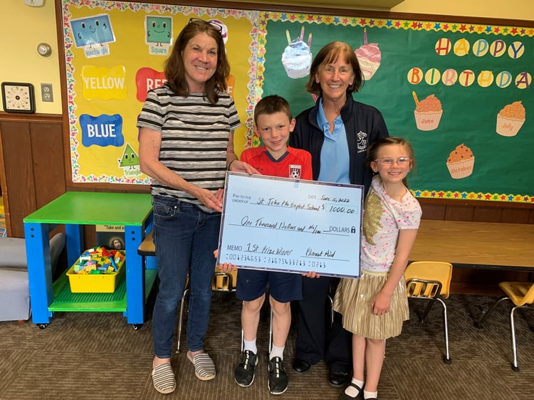 St. John the Baptist School in Ludlow, MA accepting their check for $1,000 for winning the Planet Aid clothing drive contest