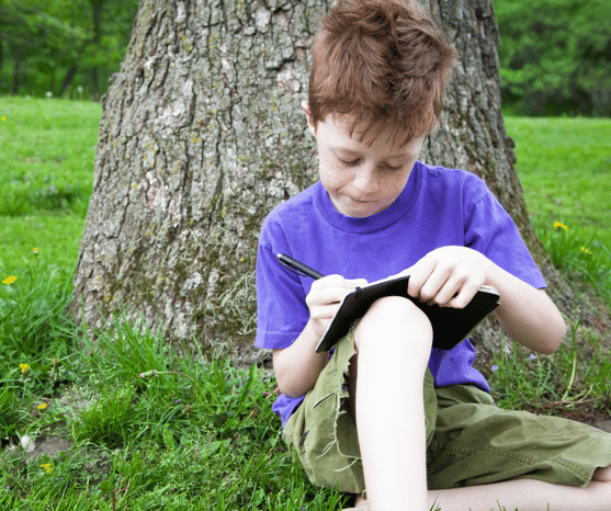 Boy nature journaling