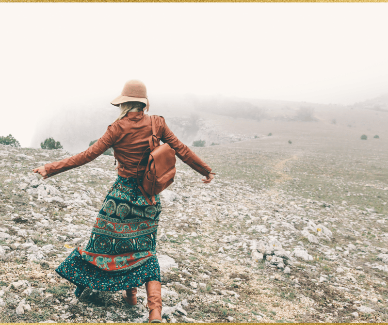 fall fashion woman walking on a hill