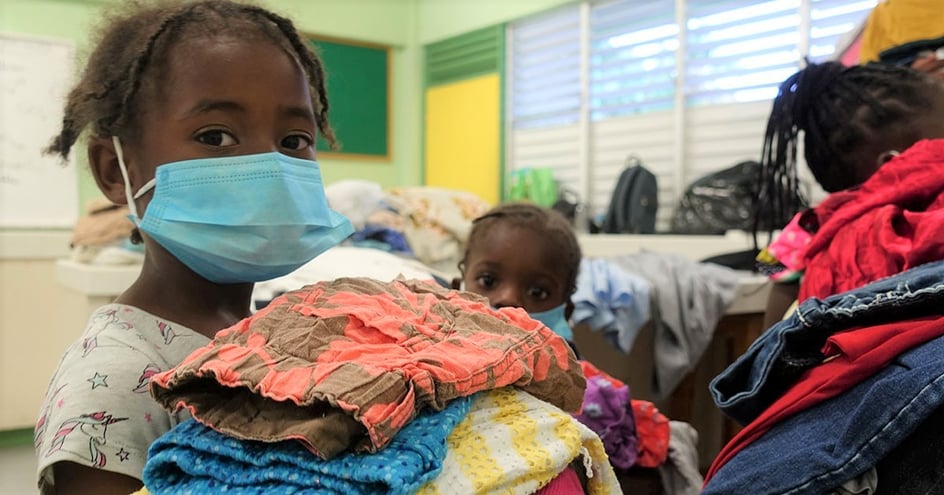 Little girl receiving donated clothing