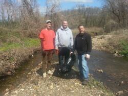 Planet Aid's Frank Rapone, David Bauer and Patrick Danielson help clean up Penny Pack Creek.