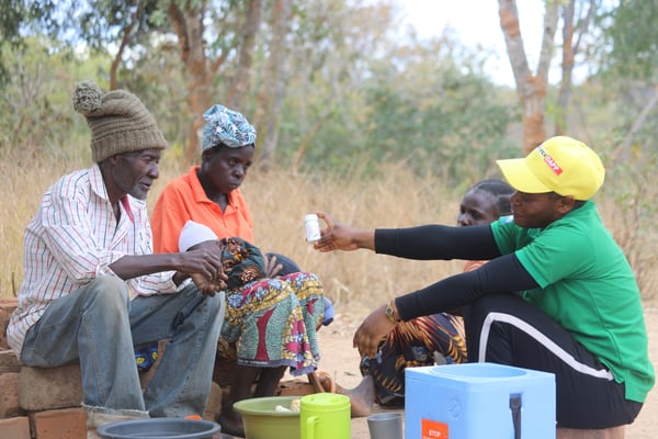 Zambia- the field officer delivering medication to a couple living with HIV